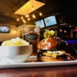 Burger and chips in front of Canmore Brewing pint at HyFive